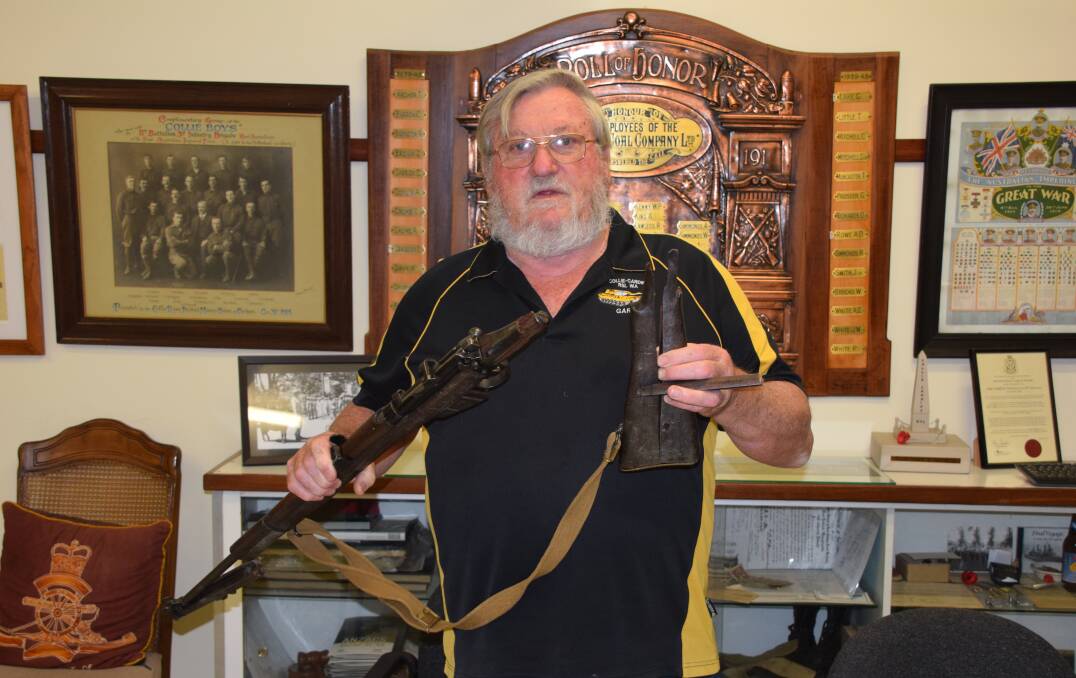 Collie-Cardiff RSL sub-branch president Gary Benton with the broken Lee-Enfield .303 rifle that was recently returned to the club. Photo: Ashley Bolt