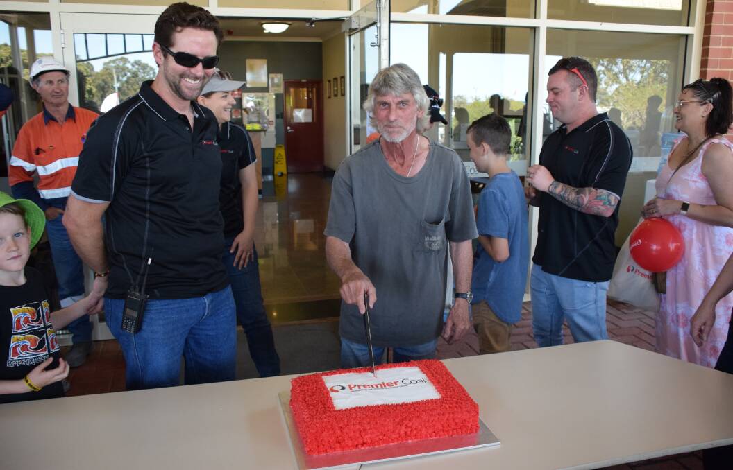 Zee Rijkuris and Livio Pierotti, who has worked for Premier Coal for 35 years, cutting the birthday cake. Photo: Ashley Bolt