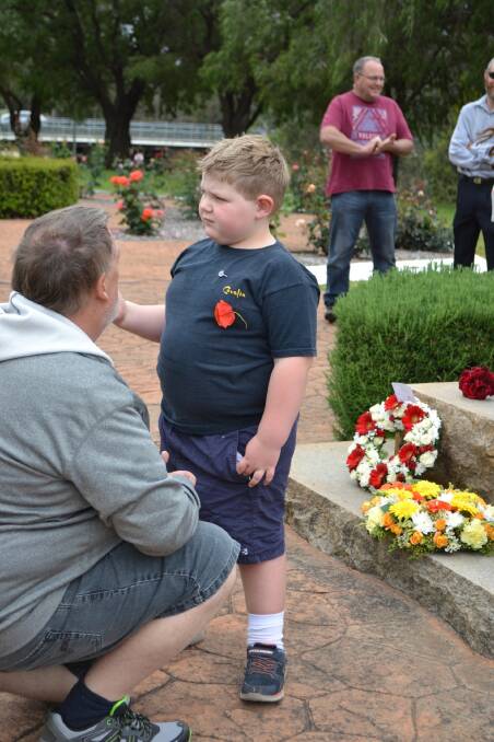 Lewis Campbell discussing Remembrance Day with his grandfather Bruce Green. Lewis said he thought people should try talking instead of fighting. Photo: Nola Green.