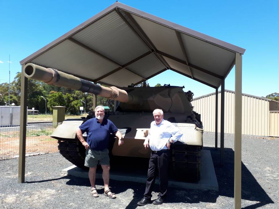 Collie-Cardiff RSL president Gary Benton and Collie-Preston MLA Mick Murray with the Leopard tank on display in front of the club's building. Photo: supplied