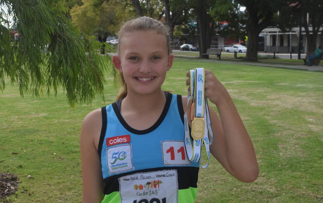An-ne Pelser with the gold and two bronze medals she won at the recent little athletics state championships. Photo: Ashley Bolt