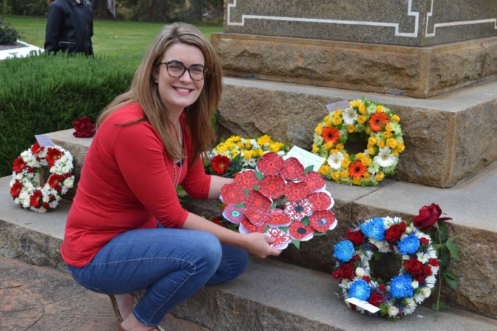 St Brigid's teacher Chelsea Roney laying a wreath at the Soldiers Park Cenotaph on behalf of her Year One students. The wreath wasn't completed in time for the school service, so she promised to lay it after the Remembrance Day service. Photo: Nola Green.