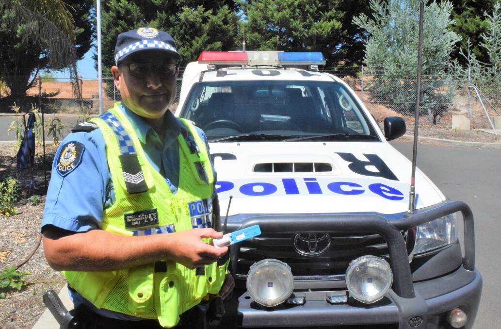 Senior Constable Greg Taylor with the new roadside drug test. Photo by Ashley Bolt.