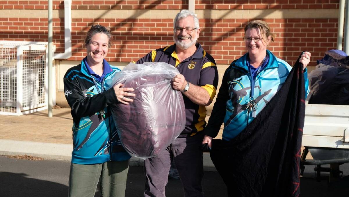 Rotary Club of Collie president John Bylund delivering blankets to Collie PCYC's Kristy Milne and Linda Gallagher. Photo supplied.