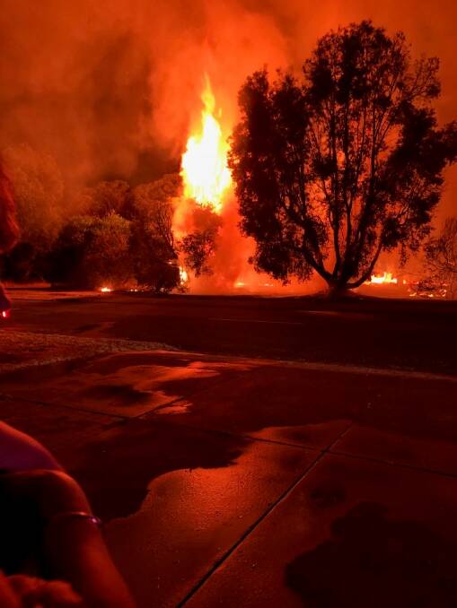 Residents watch as a fire believed to have been deliberately lit burnt parts of the Collie Golf Course. Photo: supplied. 