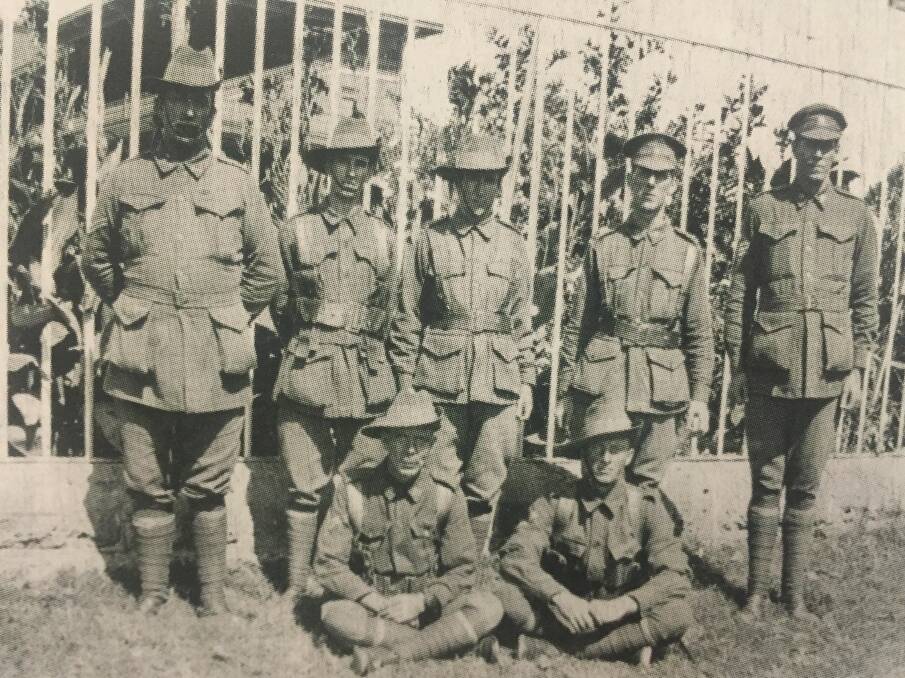 PART OF THE 10TH REINFORCEMENTS: Cpl Moran and Cpl Vernon sitting with Cpl Chapman, Sgt Preston, Lt Compton, Lt Glover and C.S.M Elfson. Photo: supplied.  