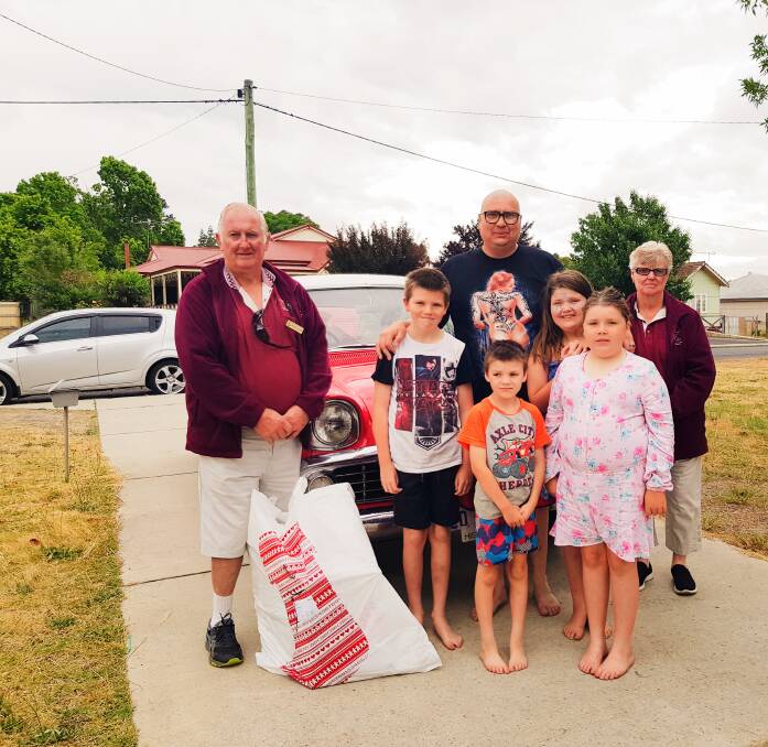 Collie Veteran Car Club members George and Jan Timms spreading the Christmas cheer to the Stephen family. Photo: supplied