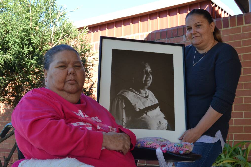 Christina Ugle holding a portrait of her grandmother Kathaleen Northover (nee Mears) with her mother Phyllis Ugle. Photo: Breeanna Tirant