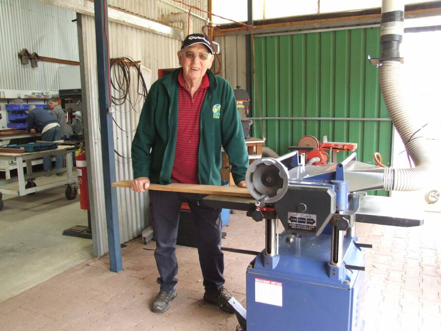Fixit Fella and Capel Men's Shed treasurer Dave Taylor putting a board through the thicknesser in readiness to embark on another project. Photo: supplied. 