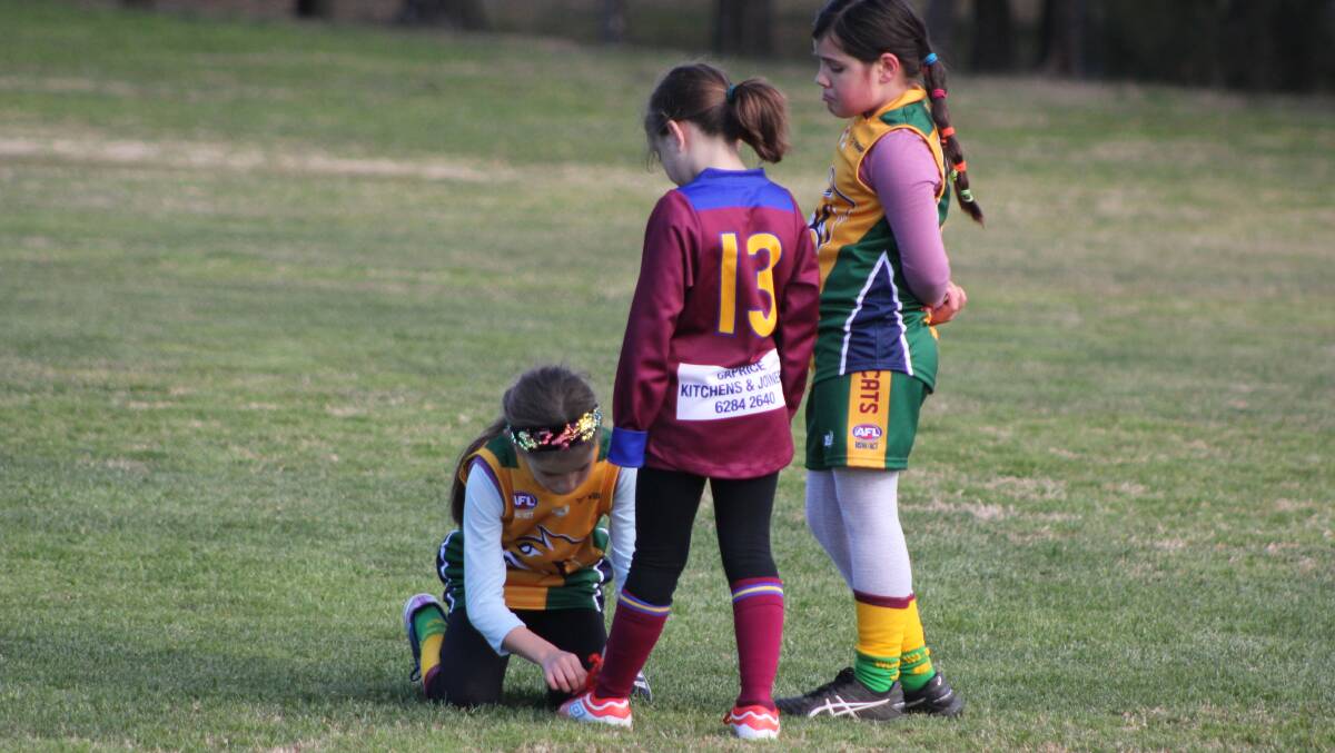 The Eddies-Marist photograph came after another parent, Luke Hickey took this photograph in 2019 at under 10s AFL game as Weston Creek Molonglo Wildcats player Gemma Klose tied the shoelace of opposition player, Tuggeranong Lions' Lily Tompkins.