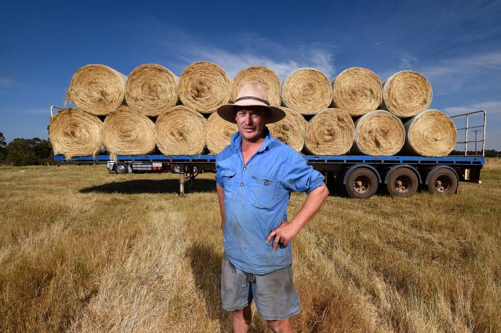 SUPPORT: Dunnstown farmer Karl Britt loaded hay onto trucks on Friday and Saturday in preparation for Sunday's drive. Pictures: Adam Trafford 