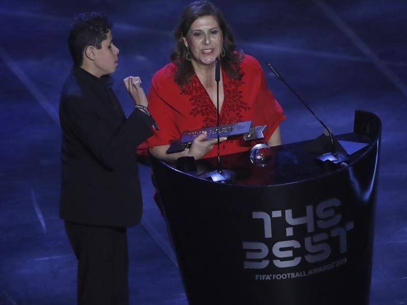 Brazilian Silvia Grecco and her son Nikollas receive the FIFA Best Fan Award in Milan on Monday.