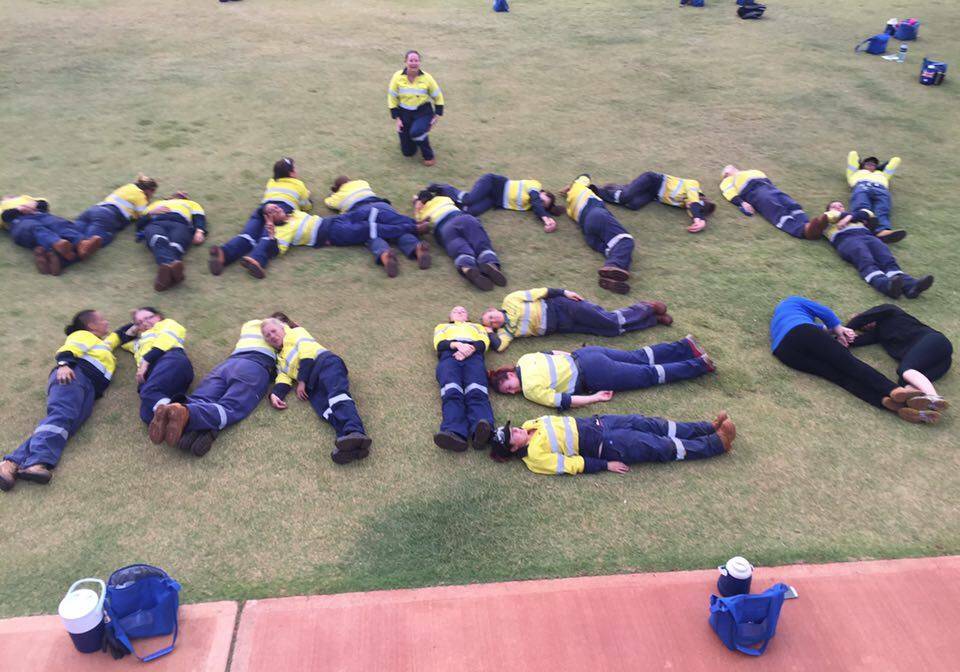 co-workers helped to spell out 'Marry me' with their bodies. 