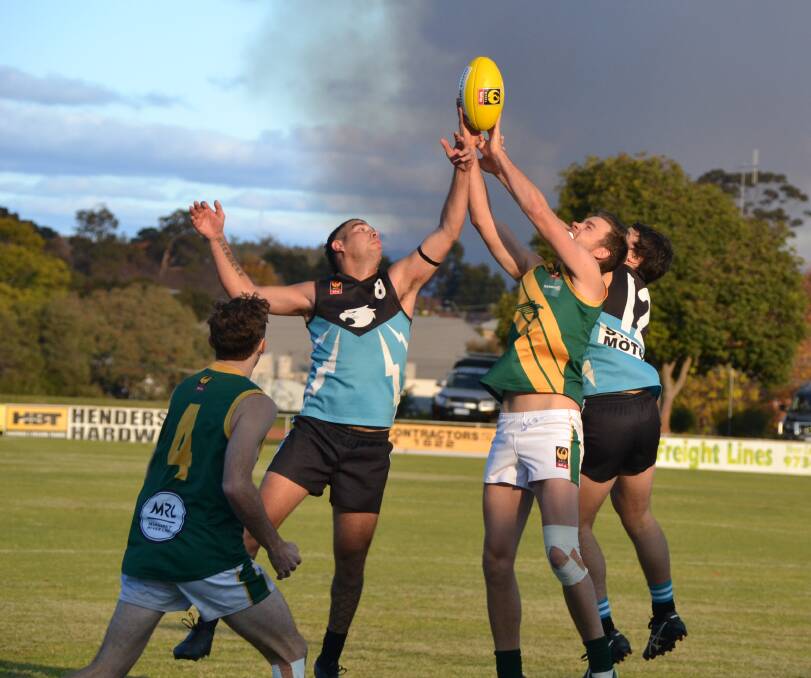 UP THERE: Collie's Matthew Michael reaches for the ball under pressure from Hawks, as the visitors claimed a victory. Photo: Breeanna Tirant.