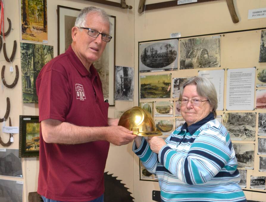 Amazing artefact: Coalfields Museum committee member Alan Wade shows Nola Green the Golden Helmet. Photo: Supplied.