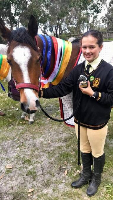 Awarded: Piper White and her horse Sereem after receiving overall champion girl in her age group. Photo: supplied.