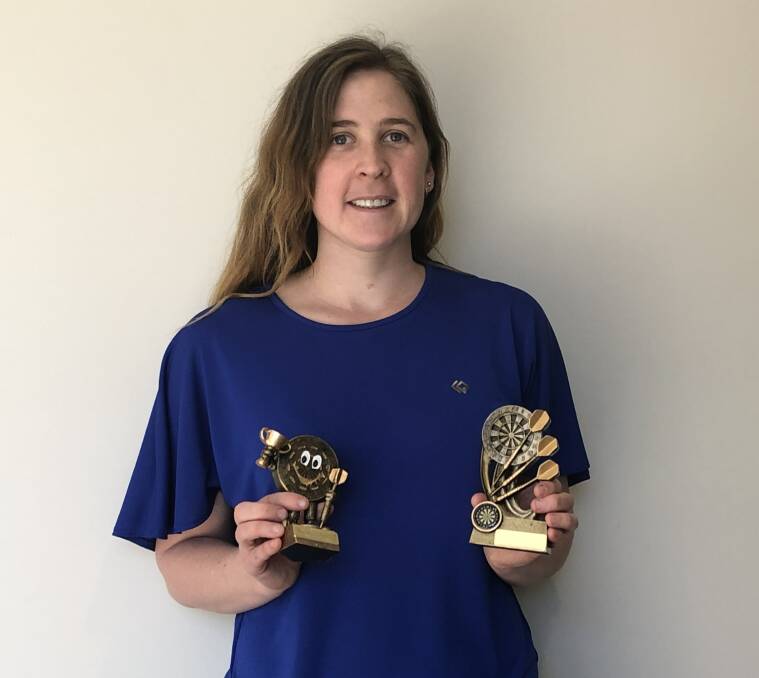 Sharp-shooter: Ashleigh Putland with her two darts trophies. Ashleigh was runner-up for Darkan Club B-grade Singles and also the winner of the Wagin Darts Association Most Improved Player Award for 2019. Photo: Supplied.