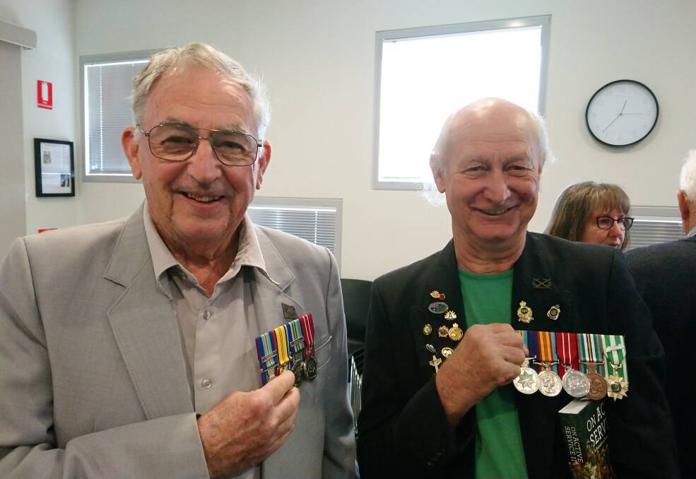 Historic good read: Gerry Hartnett with Brenton Kelly at Louise Higham's recent book launch of 'Active Service II' at the West Arthur CRC. Photo: Supplied.